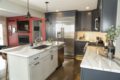 a kitchen with blue cabinetry and granite countertops.